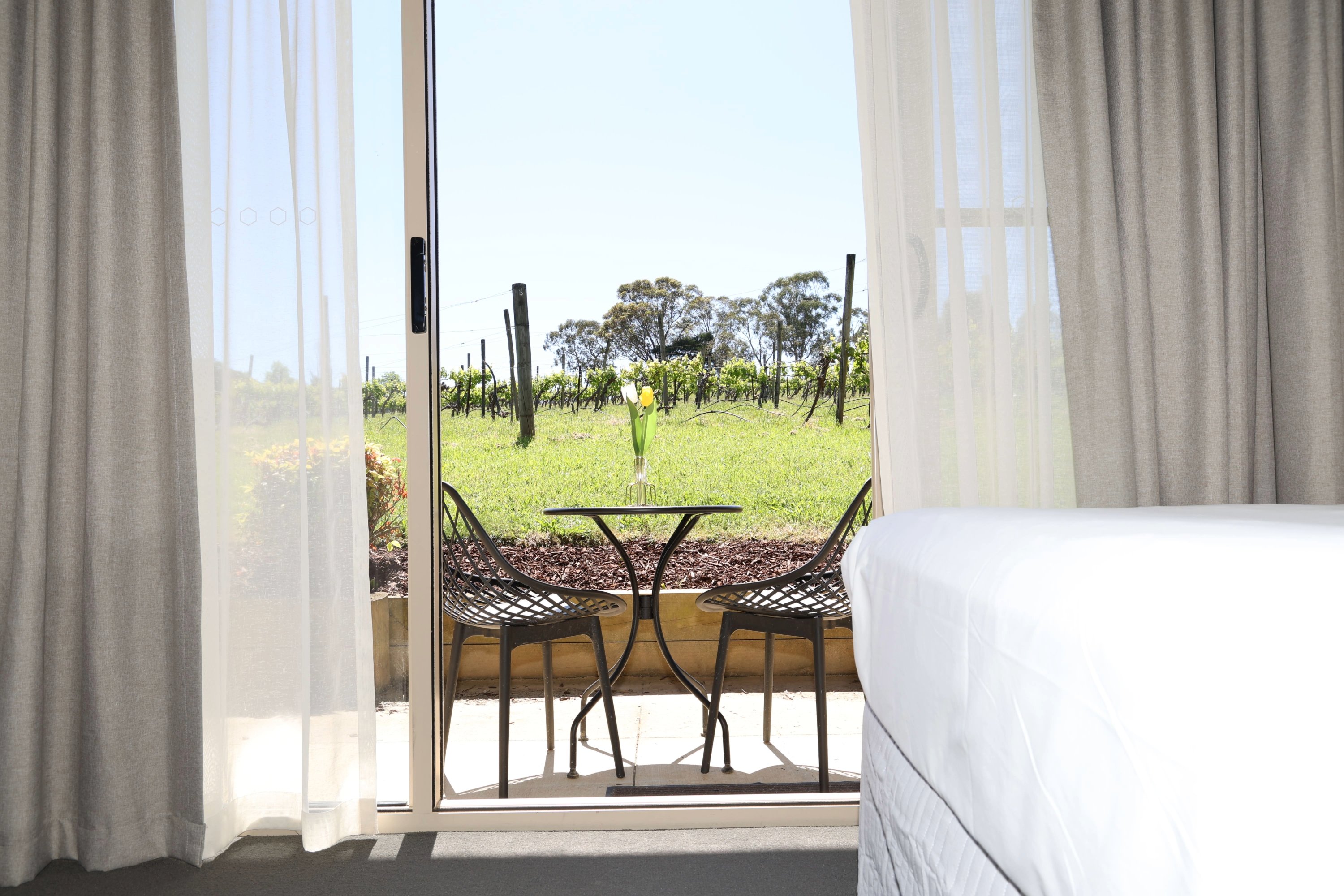 Queen Room opening onto a private patio with vineyard views