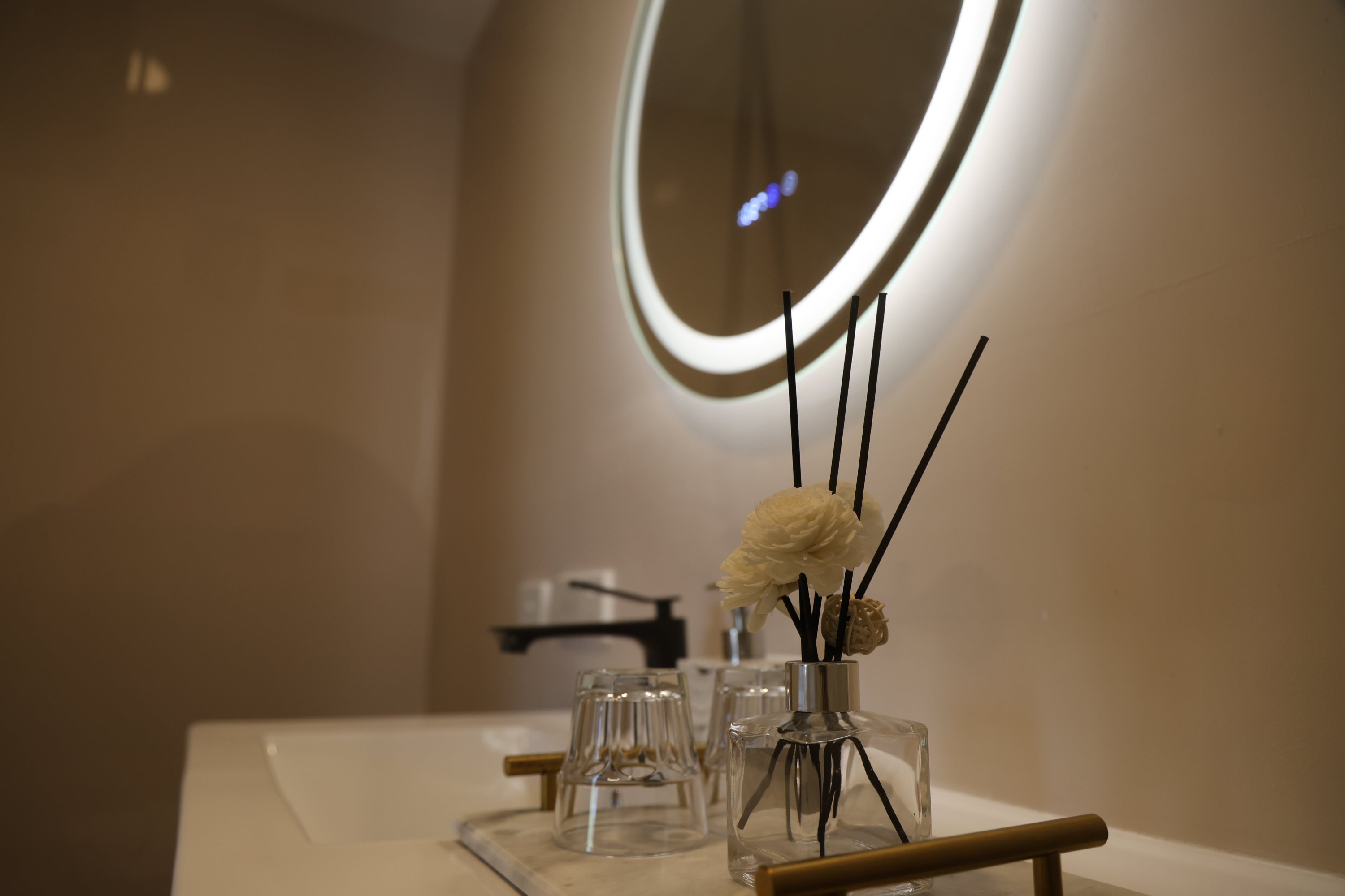 Ensuite vanity with round backlit mirror